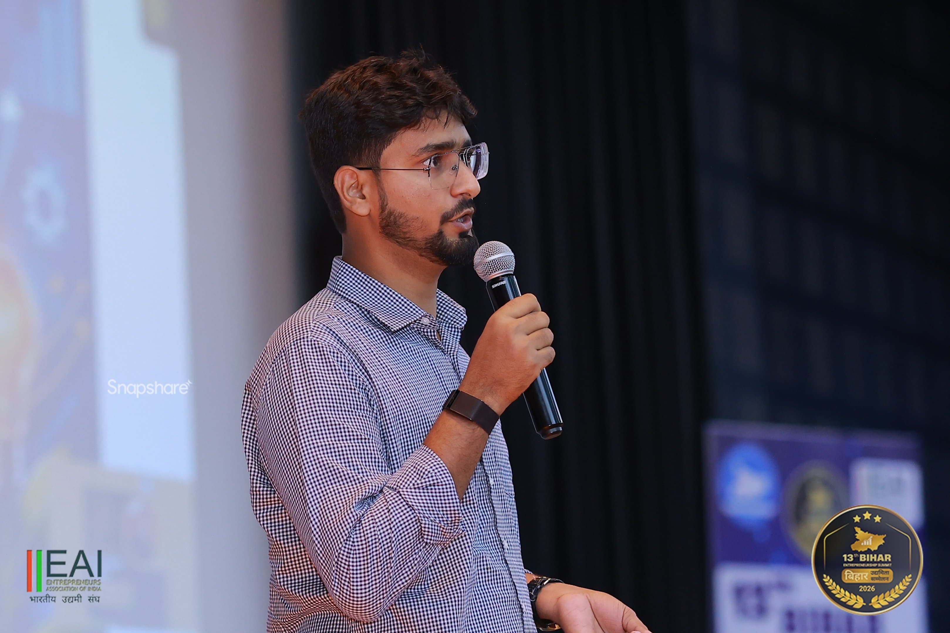 Sumit pitching Justis AI on stage